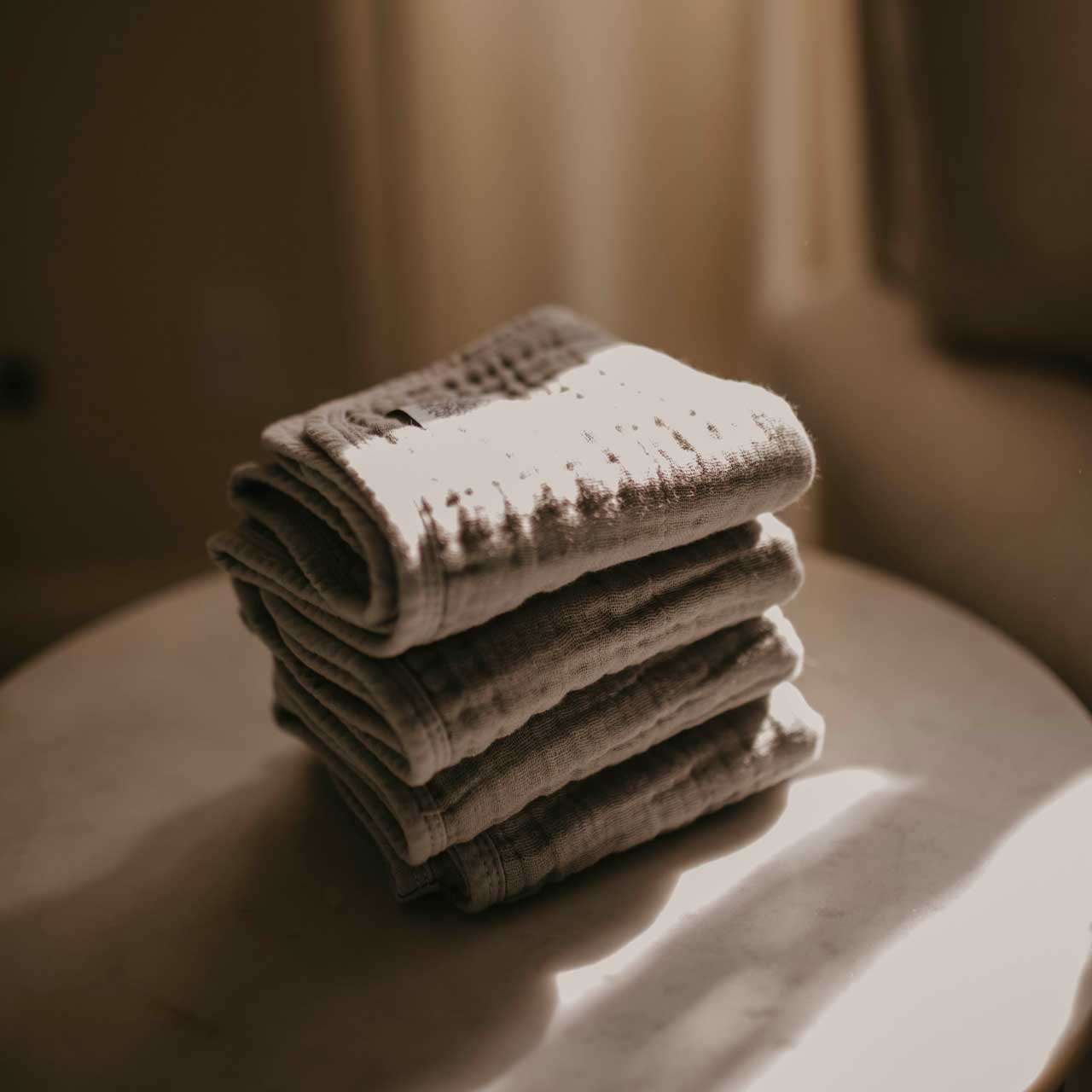 Stack of gray muslin burp cloths.
