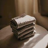 Stack of gray muslin burp cloths.