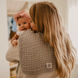 Gray burp cloth for mom's shoulder.