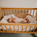 Prairie floral quilt under baby in crib