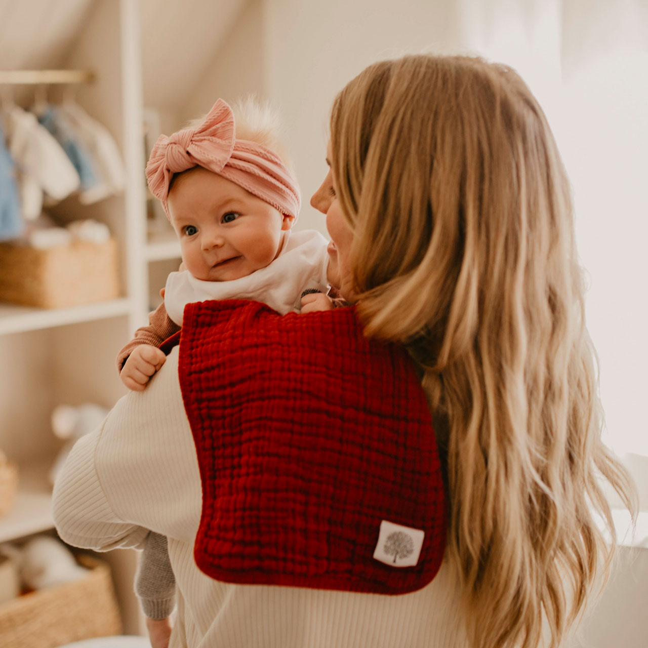 Maroon burp cloth on mom