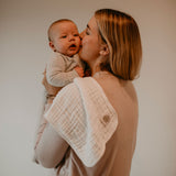 White burp cloth for mom's shoulder.