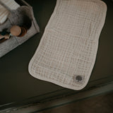 Muslin burp cloths with diaper caddy.