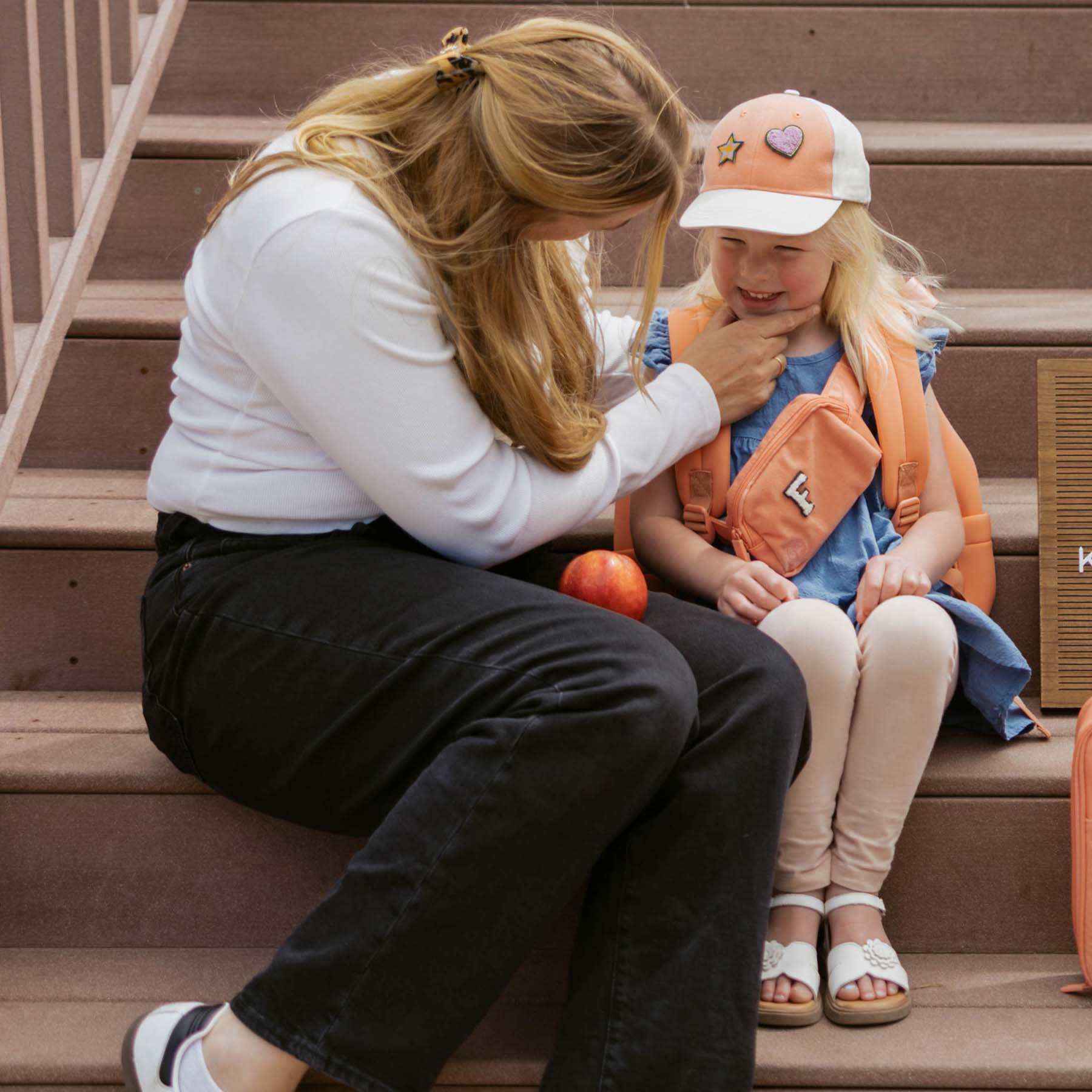 Parent and child sharing quality time at school to support character development in early childhood.
