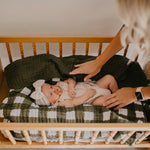 Green buffalo quilt for baby crib.