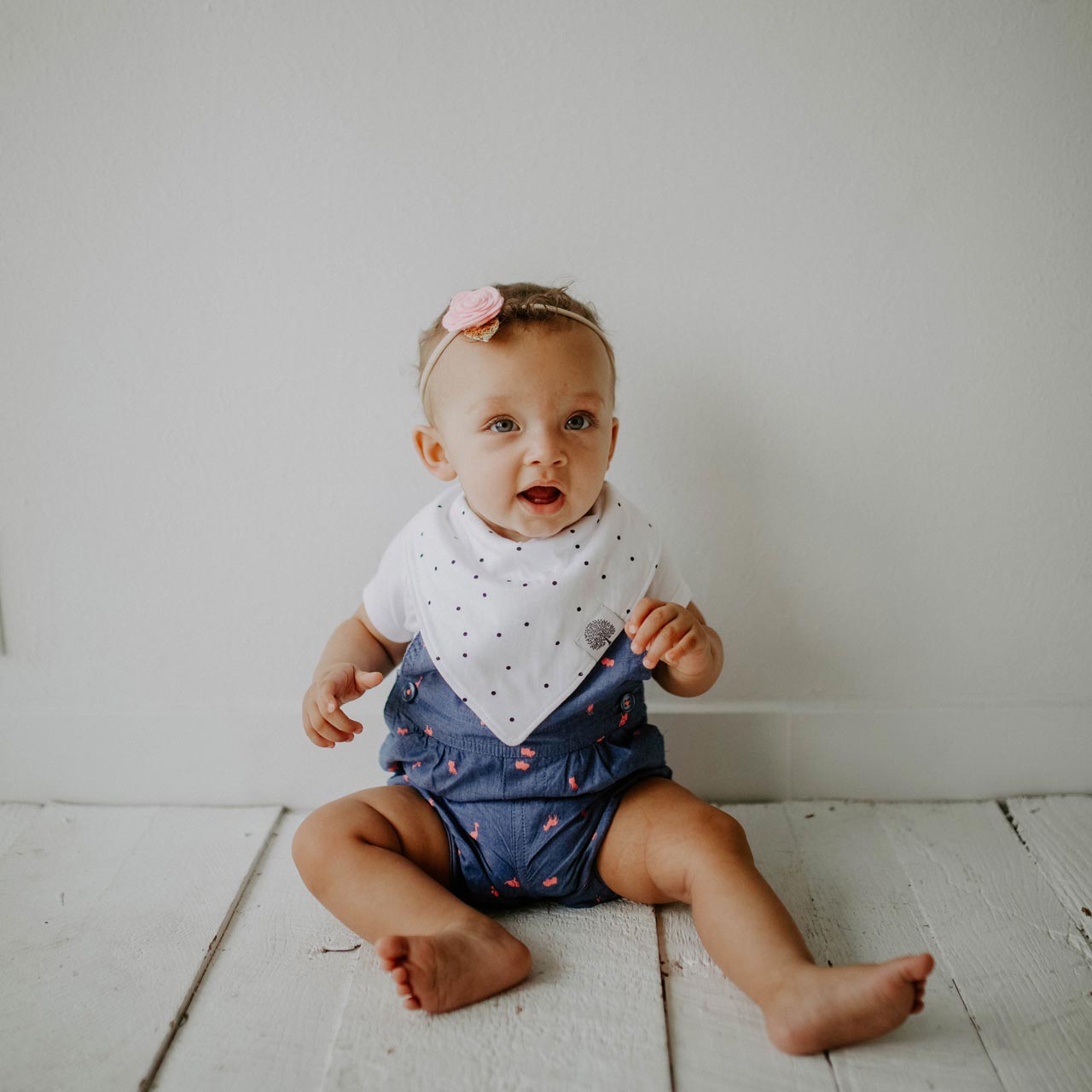 White with black dots bandana bib for baby girl.