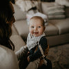 White and blacked speckled bandana bib for baby.