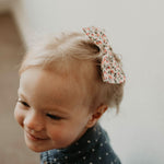 Pink flowered bow clip for toddler.
