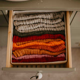 Drawer of different colored muslin burp cloths.