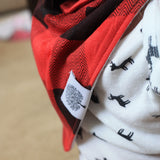 Red and black flannel bandana bib for baby boy close up.